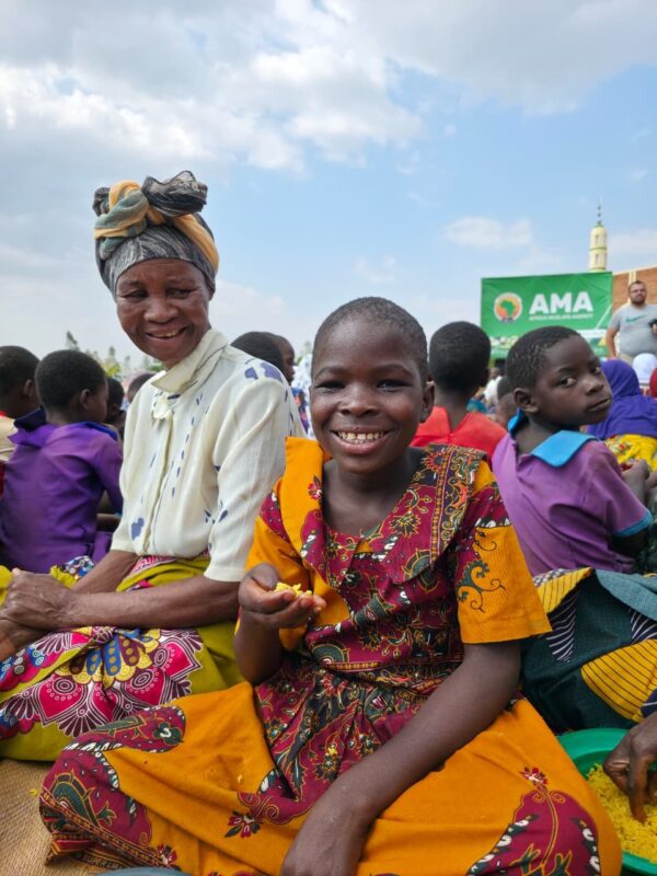 photo of Malawi locals smiling after receiving water in their area for the first time.