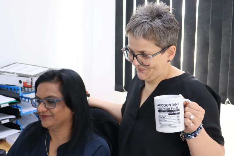 Sunitha and Linda are looking at some accounting figures on the computer
