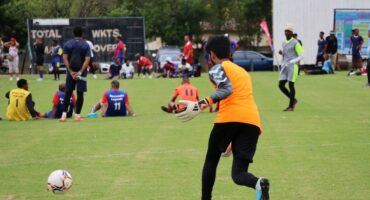 A young goalkeeper kicks the ball during a community soccer tournament at Paradise Sports Grounds.