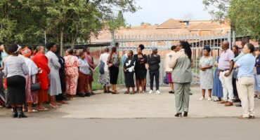 Image of parents standing outside the gates of Pro Nobis Special School, Dundee.