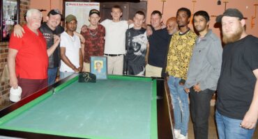 Image of pool players around the table honouring Alan Carlson.