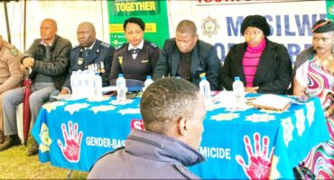Description of police officers seated around a table during a Heritage Day event in Glencoe.