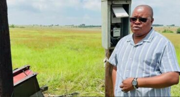 An image of AbaQulusi Local Municipality Mayor, Sifiso Mkhwanazi next to the destroyed transformer. He urges residents to report suspicious activities to authorities .