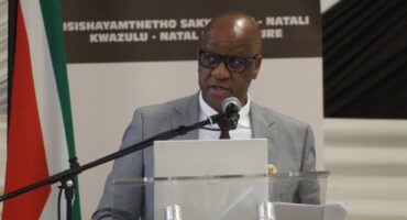 Image of the KZN Premier Thami Ntuli speaking on a micro-phone at the 'Taking Legislature to the People' programme.