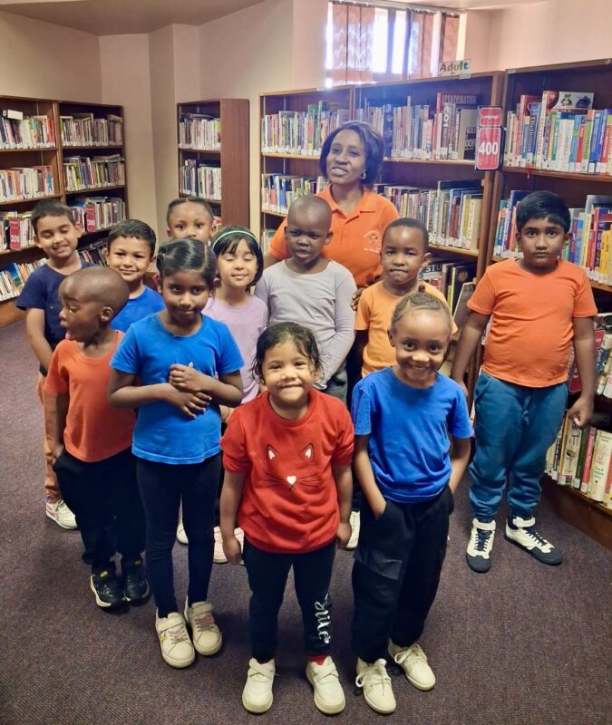 A group of pre-primary children pictured in colourful T-shirts at a local library in Newcastle.