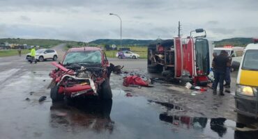 Accident scene with truck on its side and a bakkie is crumbled up on the front.