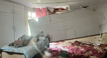 Collapsed ceiling and water damage inside a flooded care home room.