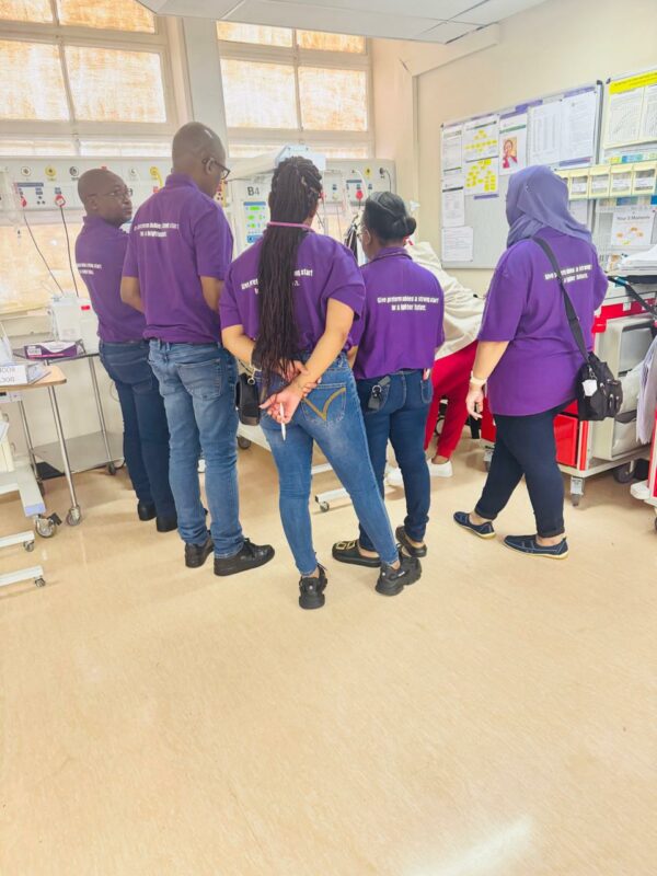 A group of people dressed in purple pose for a photo for World Premature Day at the Newcastle Provincial Hospital.