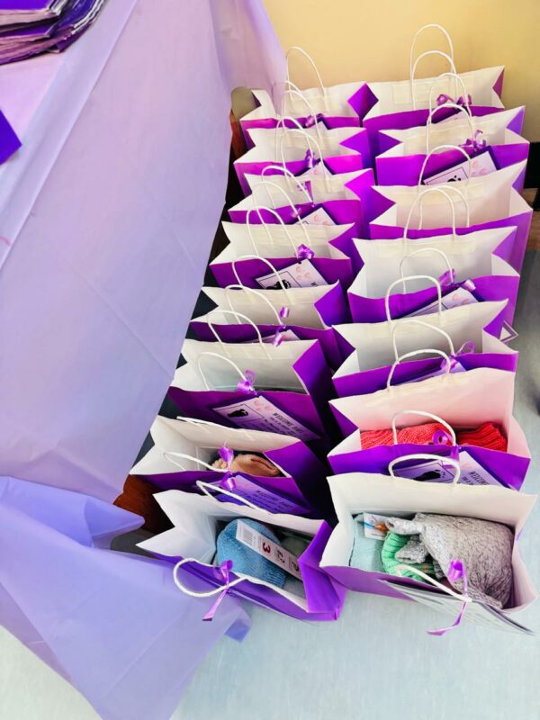 Purple and blue gift bags filled with goodies to celebrate World Prematurity Day.