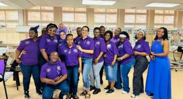 A group of people dressed in purple pose for a photo for World Premature Day at the Newcastle Provincial Hospital.