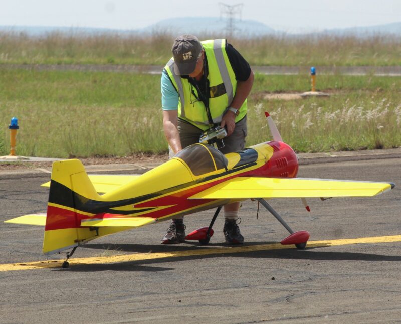 A model aircraft pilots checking his plane at the Newcastle Airport.