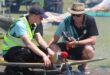 Two model aircraft pilots checking their plane at the Newcastle Airport.