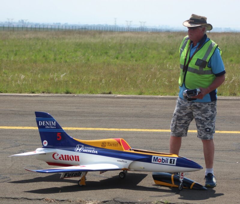 A model aircraft pilots checking his plane at the Newcastle Airport.
