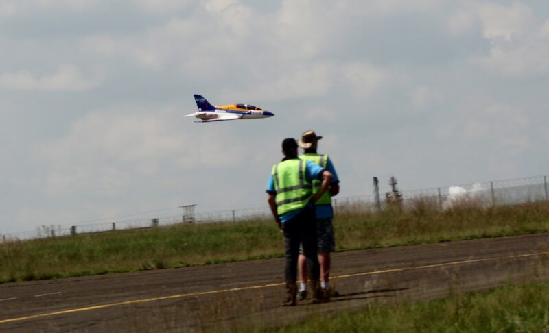 Two model aircraft pilots checking their plane at the Newcastle Airport.