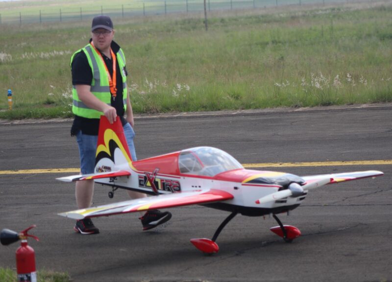 A model aircraft pilots checking his plane at the Newcastle Airport.