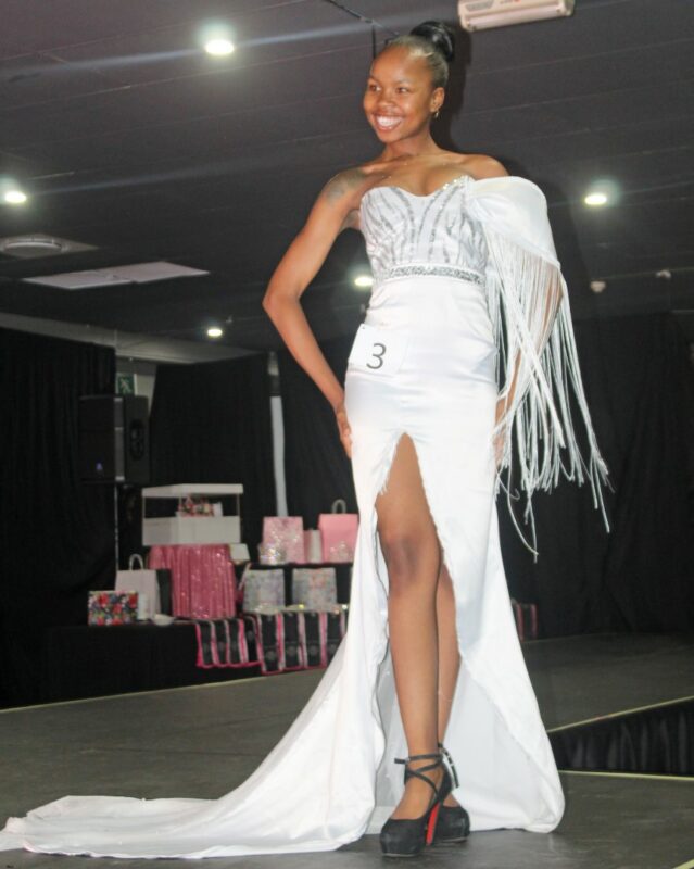 A young pageant queen dressed in beautiful evening wear on the Miss Wonder Woman Beauty pageant Stage in Newcastle.