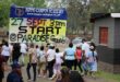 Participants walk towards the starting point of the Hippo-Campus Academy Colour Run at Paradise Grounds, beneath a large event banner.