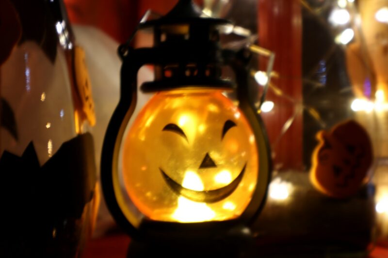 A glowing lantern with a smiling jack-o'-lantern face, surrounded by warm string lights is pictured at a local Halloween Cosplay event at Fort Amiel in Newcastle KwaZulu-Natal.