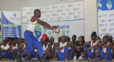 Image of Mthashana College students singing and dancing to Ingoma which is a Zulu traditional dance.