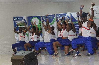 Image of Mthashana College students with hands in the air as they do their traditional dances for entertainment purposes at the launch