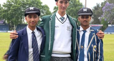 Three young boys are pictured in their school uniforms after being selected fro the KZN Inland Cricket team. All three are wearing their KZN Inland Cricket caps.