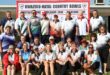A large group of Bowlers pose in front of a Kwazulu-Natal Country Bowls banner.