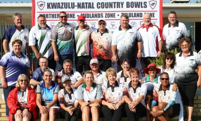 A large group of Bowlers pose in front of a Kwazulu-Natal Country Bowls banner.