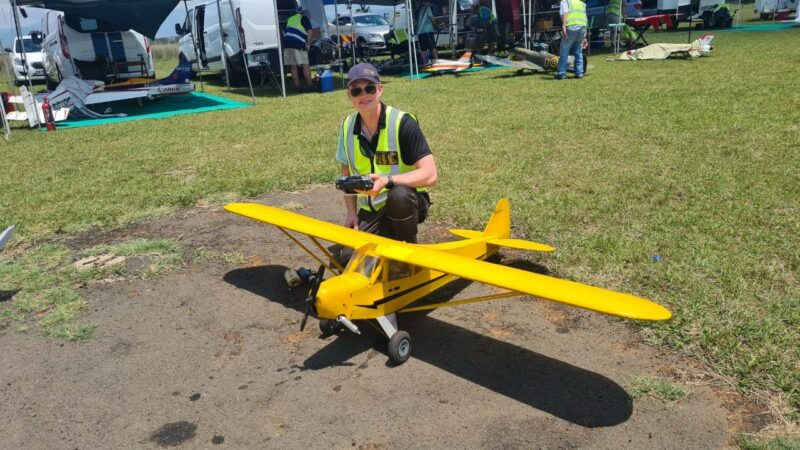 A model aircraft pilots checking his plane at the Newcastle Airport.