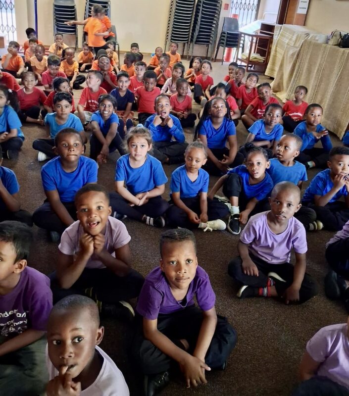 A group of pre-primary children pictured in colourful T-shirts at a local library in Newcastle.