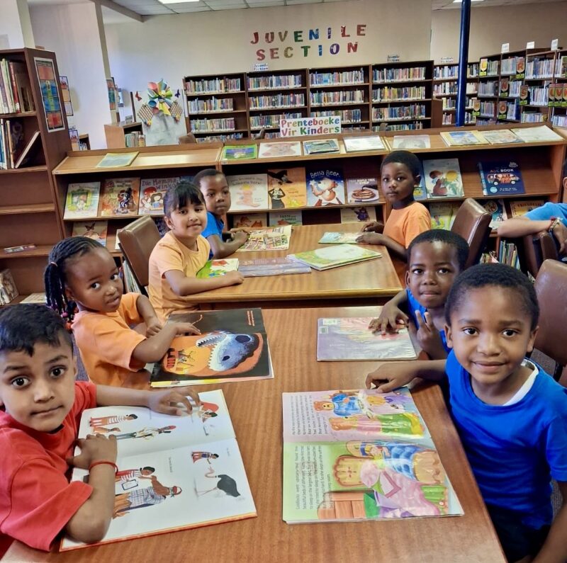 A group of pre-primary children pictured in colourful T-shirts at a local library in Newcastle.