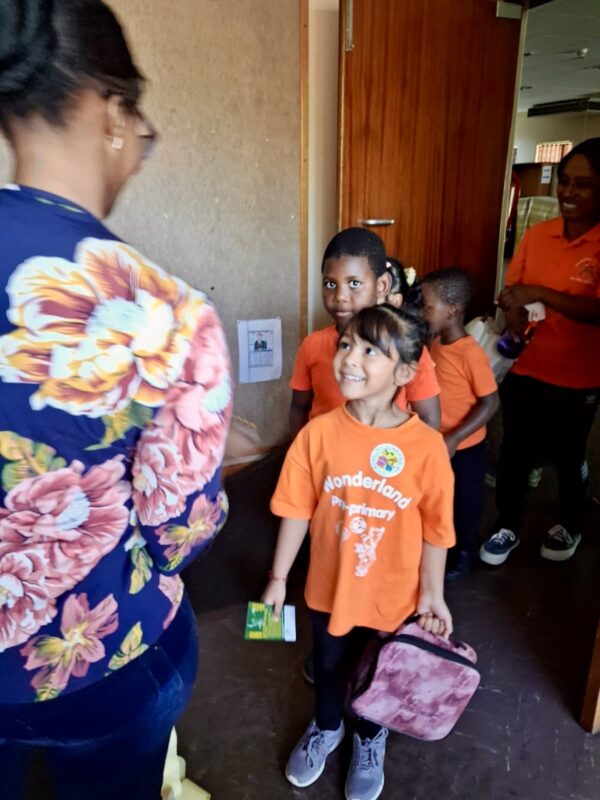 A group of pre-primary children pictured in colourful T-shirts at a local library in Newcastle.