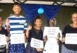 Image of Forestdale residents holding placards condemning GBV.