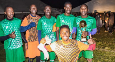Image of football players in Dundee with a trophy.