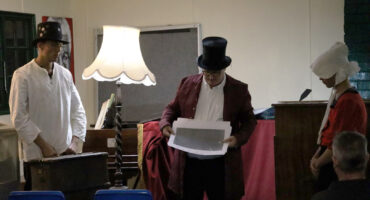 Actors in period costume perform ghost storytelling at Fort Amiel.
