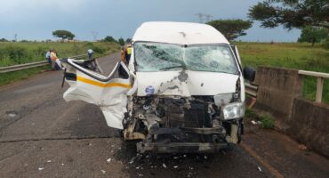 Image of taxi involved in crash on the front. Door open but crumbled up.