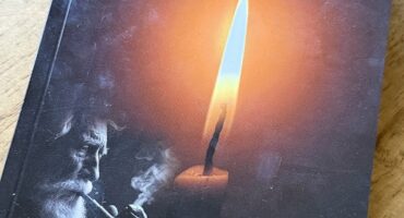 Image of book with a burning candle on the cover with the author name and name of book, Sout op die Kers.