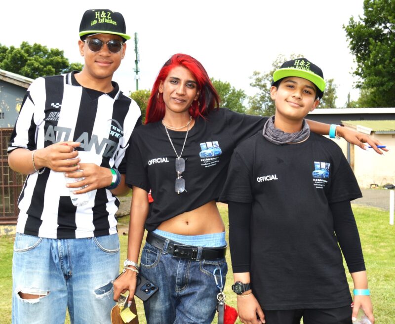 A group of people appearing to be very excited pose for a picture during a Christmas Bazaar.