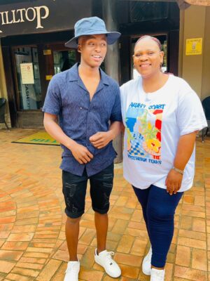 An image of Thulani Mncube, a grade 12 learner at KwaNotshelwa High School with his teacher Miss Makathini at the EDTEA's retreat in Hluhluwe.