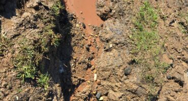 Image of a burst water pipe and the subsequent diversion.