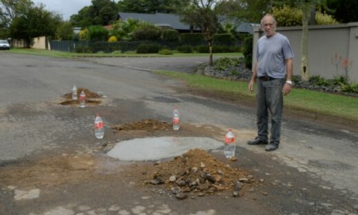 Image of resident fixing potholes in Dundee.