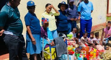 Image of police and officials with donation parcels.