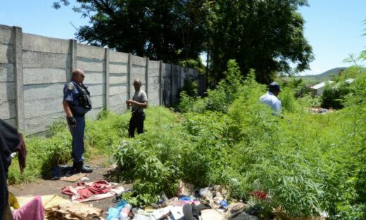 A police officer inspects the vacant plot in Beaconsfield Street, which has caused great alarm in Dundee's CBD
