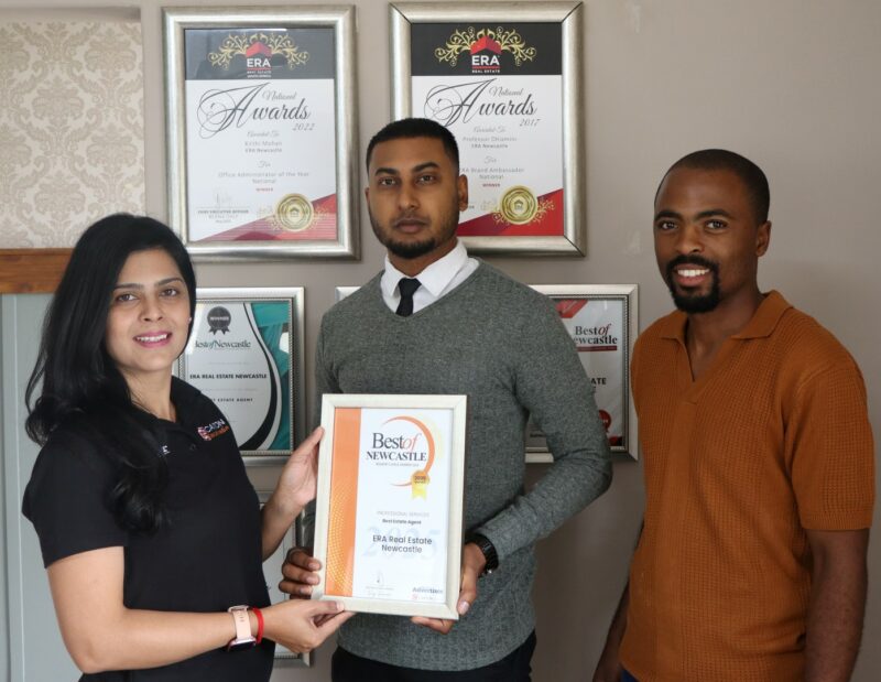 Newcastle Advertiser staff members hand over certificates to a Best of Newcastle Reader's Choice Award winner.