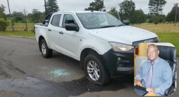Two images compiled together. One image is of a white doublecab Isuzu bakkie, riddled with bullet holes and the second is of a municipal official from Newcastle Municipality.