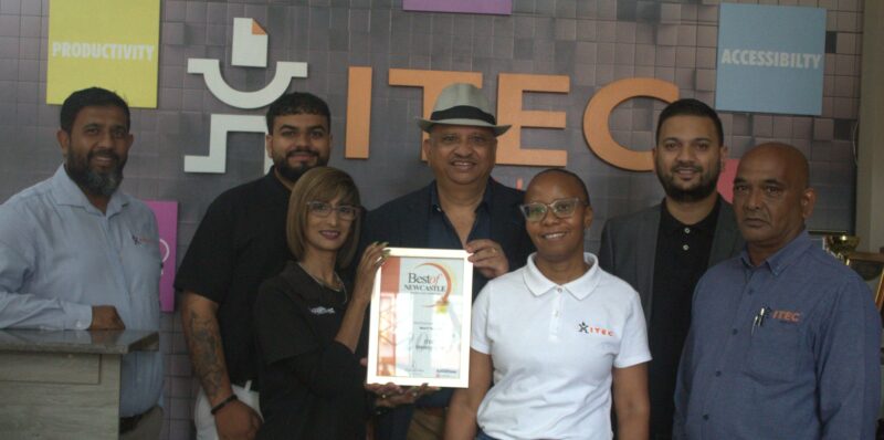 Newcastle Advertiser staff members hand over certificates to a Best of Newcastle Reader's Choice Award winner.