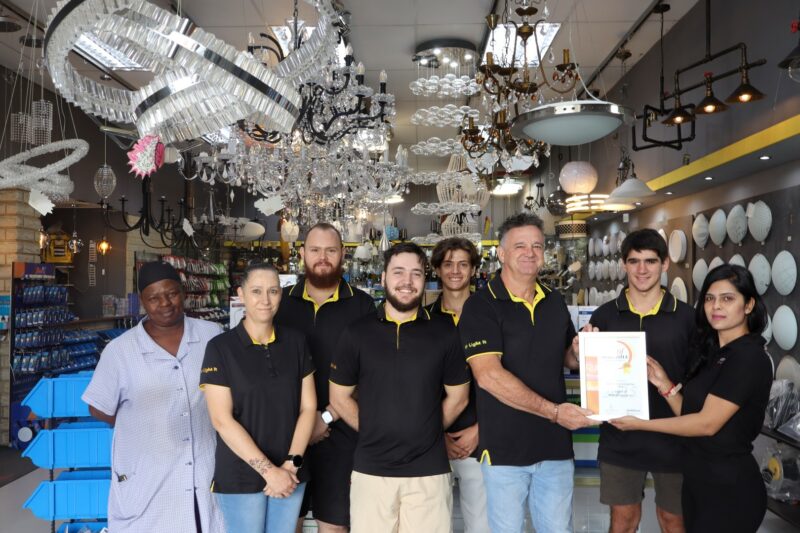 Newcastle Advertiser staff members hand over certificates to a Best of Newcastle Reader's Choice Award winner.