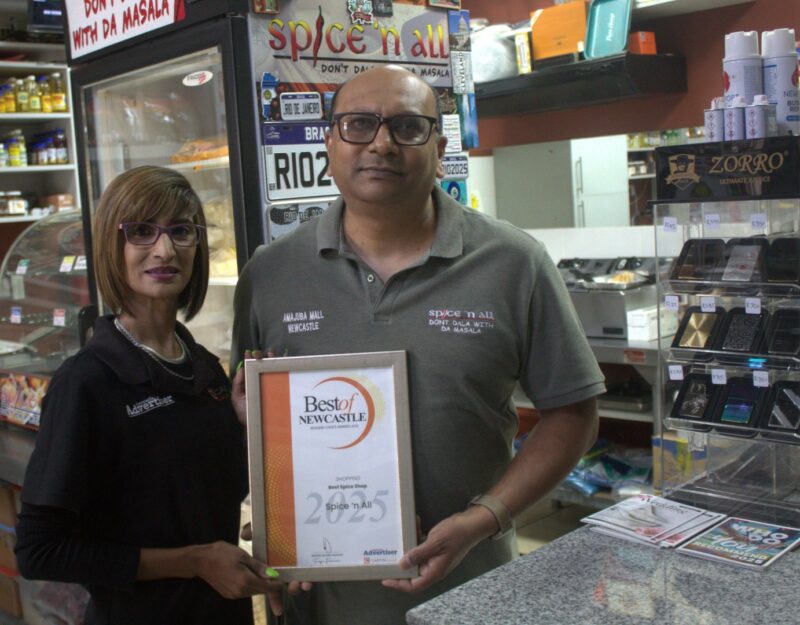 Newcastle Advertiser staff members hand over certificates to a Best of Newcastle Reader's Choice Award winner.