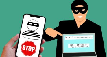 Illustration of a scammer attempting to steal passwords via phone and laptop.