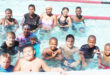 Image of high school in a swimming pool supporting a Rotary Swim-A-Thon in aid of the fight against polio.