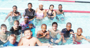 Image of high school in a swimming pool supporting a Rotary Swim-A-Thon in aid of the fight against polio.